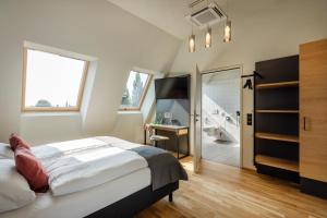 a bedroom with a bed and a bathroom at JUFA Hotel Bregenz in Bregenz
