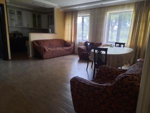 a living room with a table and chairs at Apartament 1 in Batumi