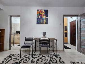 a dining room with a table and two chairs at Cluj Zorilor Residence in Cluj-Napoca