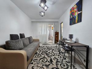 a living room with a couch and a table at Cluj Zorilor Residence in Cluj-Napoca +16 photos