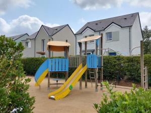 a playground with two blue chairs and a slide at L'AIGRETTE - Appartement 5 pers - Courseulles port de plaisance in Courseulles-sur-Mer