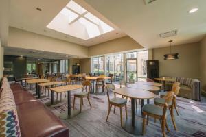 a restaurant with tables and chairs and a skylight at Courtyard by Marriott Nashua in Nashua