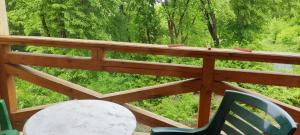 a porch with two chairs and a table and trees at Сонячна Долина готель Фортеця in Boyany