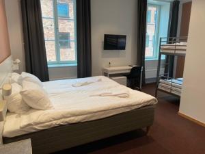 Säng eller sängar i ett rum på Ahlgrens Hotell Bed & Breakfast