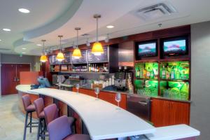 a bar in a restaurant with a counter and chairs at Courtyard Mobile Spanish Fort/Eastern Shore in Spanish Fort