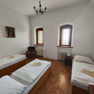 a large room with two beds and two windows at Smolenický zámok in Smolenice