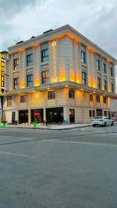 a large building with a car parked in front of it at Loft Park Hotel's in Arnavutköy