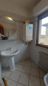 a bathroom with a sink and a mirror at Villesse Centro 