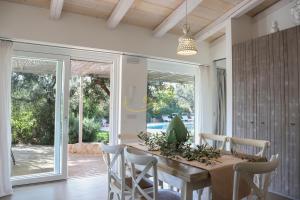 a dining room with a table and chairs and sliding glass doors at Trulli&Dimore- Il Vecchio Fienile in Polignano a Mare