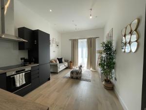a living room with a kitchen and a living room with at Luxury 2 bedroom Flat Sutton in Sutton