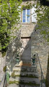 ceglany budynek z drzwiami i schodami z przodu w obiekcie Ancien Presbytère de charme w mieście Thédirac