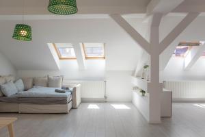 a bedroom with a bed and some skylights at High Light Apartment in Budapest