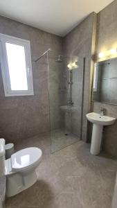 Un baño con ducha, inodoro y lavabo. en Laertis Apartments - by IMH Travel & Tours, en Pafos