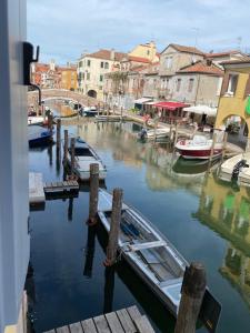 a boat docked at a dock in a harbor at Elva Suite House in Chioggia