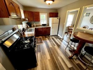 a kitchen with a sink and a stove top oven at Blue Birdhouse - Indiana Dunes - Pet Friendly in Chesterton