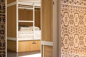 a bedroom with a bunk bed and a closet at The Lighthouse Hostel in Sagres