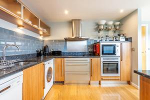 a kitchen with stainless steel appliances and wooden cabinets at 11 Stonegate Court in York +16 photos