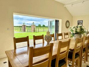 a dining room with a wooden table and chairs at Country Retreat in York