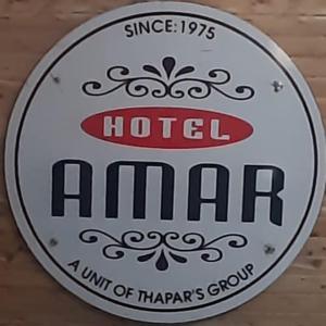 a sign for a hotel al bar on a wall at Hotel Amar in Mussoorie