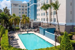 an image of a swimming pool in front of a building at Residence Inn Port St Lucie in Port Saint Lucie