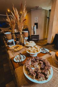 a long table with several plates of food on it at Ferraretto Guarujá Hotel & Spa in Guarujá