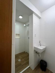 a white bathroom with a sink and a shower at Loft Mirante 3224 in Sao Paulo