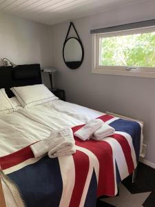 a bedroom with an american flag blanket on a bed at Studio 51 Örgryte in Gothenburg