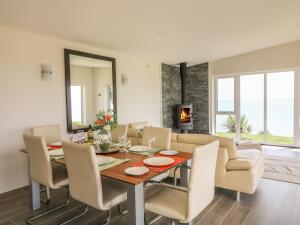 a dining room with a table and chairs at Beach House in Gorey