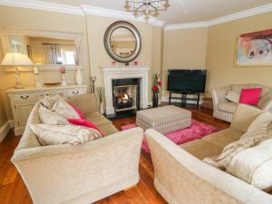 a living room with two couches and a fireplace at Glasmor Country House in Fieries