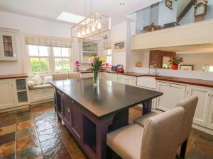 a kitchen with a center island with a vase of flowers on it at Glasmor Country House in Fieries
