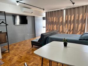 a living room with a couch and a table at Loft Mirante 3224 in Sao Paulo