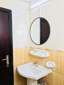 a bathroom with a sink and a mirror at Mermaid Beach Hotel LLC in Ajman 