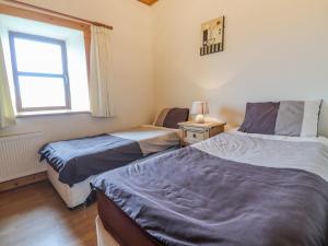 Postel nebo postele na pokoji v ubytování Clogher Cottage