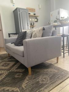 a grey couch sitting in a living room at Keikei’sHaven in Gros Islet