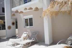 a group of chairs and a table on a patio at Villa Pastida - Private Pool and Jacuzzi in Pastida