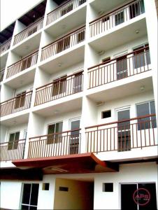 a white building with balconies on the side of it at Condo Premium Near NAIA T123 in Manila