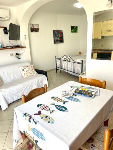 a dining room with a table and two beds at Conti Holiday Homes in Ponza