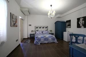 a bedroom with a bed and a blue cabinet at Il Gigante Che Dorme in Castel Castagna +64 photos