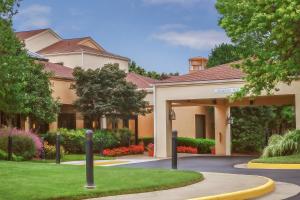 a large house with a driveway in front of it at Courtyard Manassas Battlefield Park in Manassas