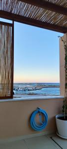 a window with a view of the ocean at Kallistis Beach House in Monolithos +28 photos