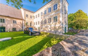 a car parked in a yard in front of a building at Lovely Apartment In Persenbeug-gottsdorf With House A Panoramic View in Persenbeug-Gottsdorf