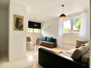 a living room with a couch and a table at Familly Apartament 2 in Międzyzdroje