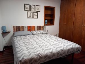 a bedroom with a large bed with a wooden headboard at LA CASA IN PIAZZA in Capracotta
