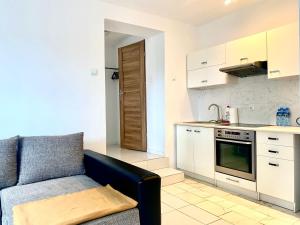 a living room with a couch and a kitchen at Familly Apartament 2 in Międzyzdroje
