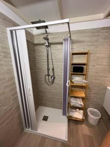 a shower in a bathroom with a glass door at Casina dei Fiori in Molfetta +20 photos
