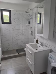 a white bathroom with a sink and a shower at Come&Enjoy in Craiova +9 photos