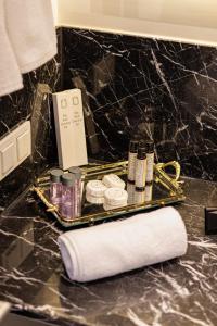 a tray with toiletries on a counter in a bathroom at Cihangir Residences in Istanbul