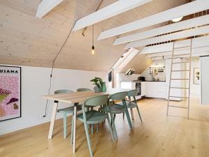 a kitchen and dining room with a table and chairs at Charming Rooftop Apartment In Heart Of Stavanger in Stavanger