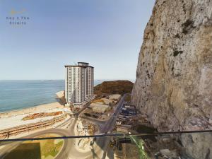 a view of a city from a cliff next to the ocean at NEW Luxury Sunrise Oceanview Aparthotel in Gibraltar in Gibraltar