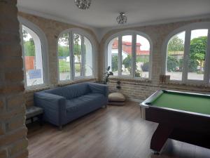a living room with a couch and a pool table at Leon's Rooms in Żary